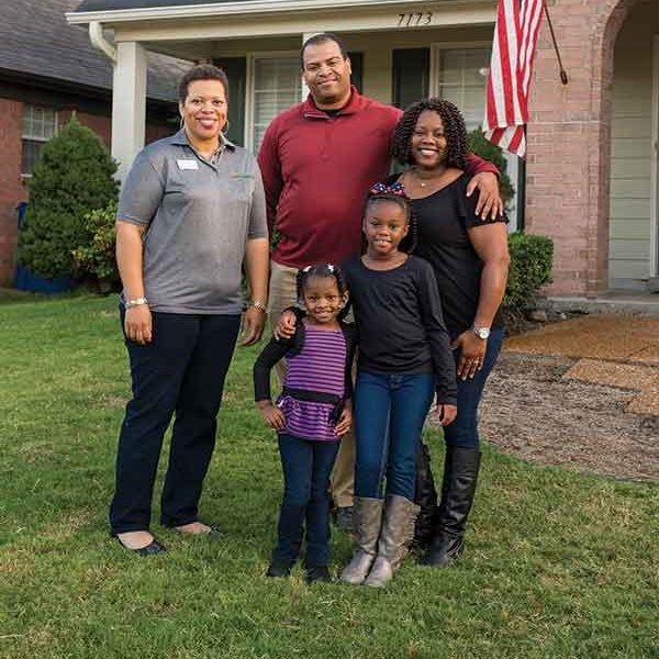 Family standing outside of their first home 